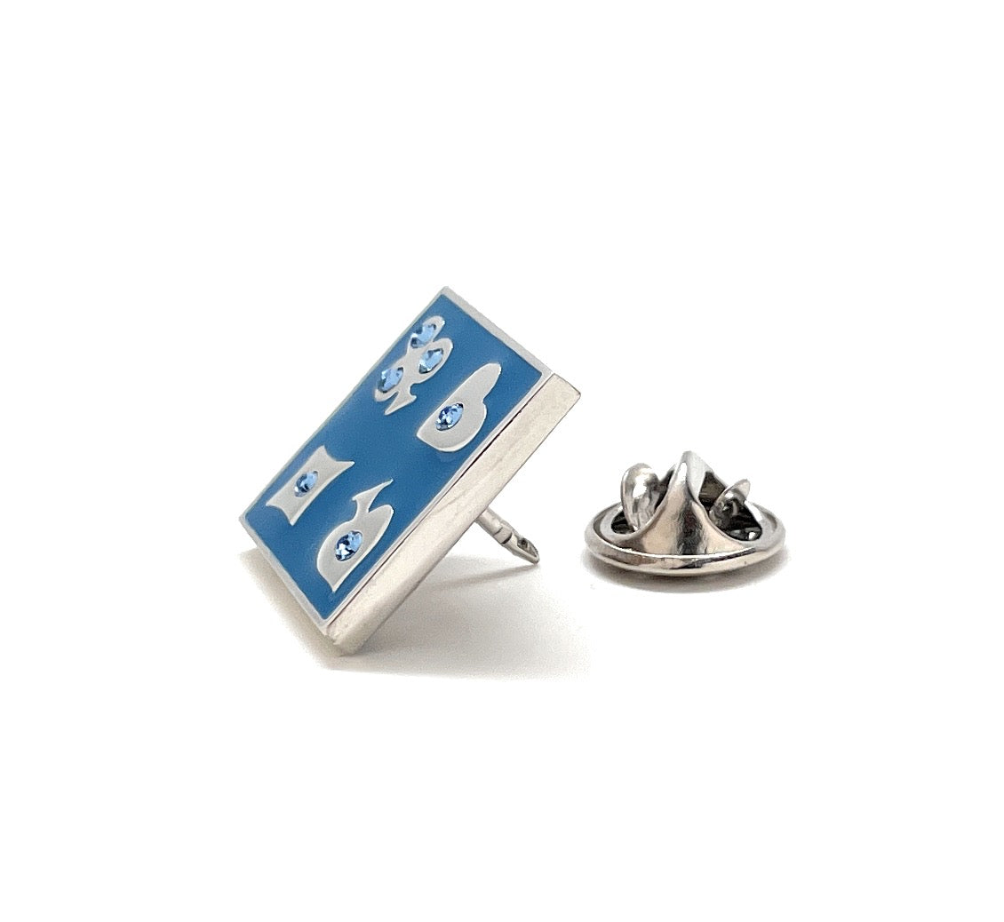 Rectangular blue pin with white designs on a white background