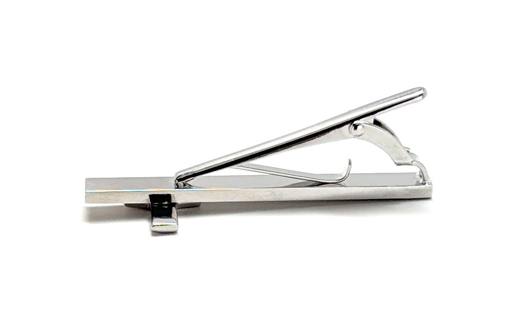 Silver tie clip on a white background