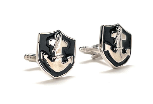 Shiny silver and black anchor cufflinks on a white background