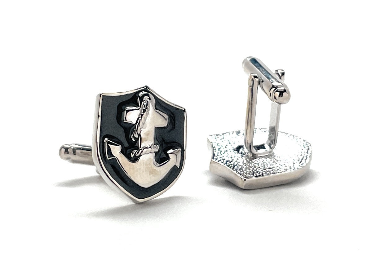 Silver and black cufflinks on a white background