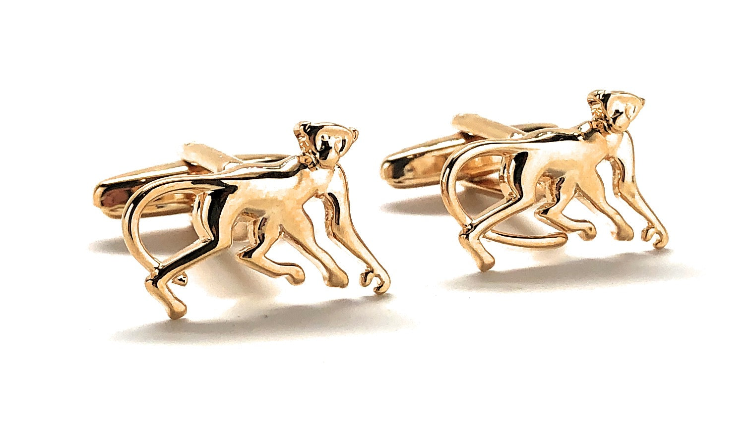 Gold monkey-shaped cufflinks on a white background