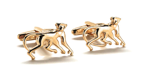 Gold monkey-shaped cufflinks on a white background