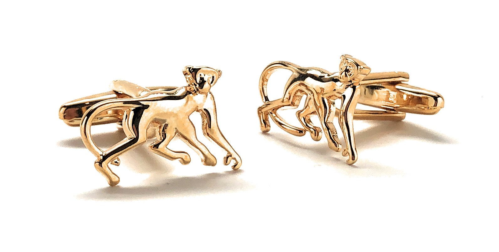 Gold monkey-shaped cufflinks on a white background