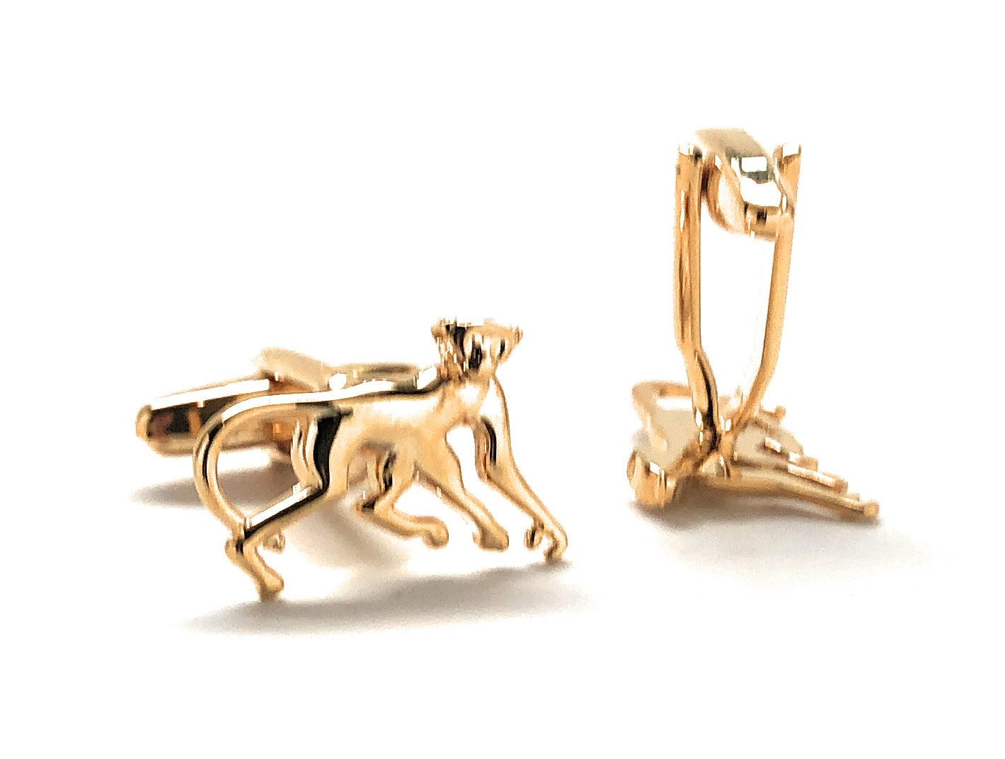 Gold monkey-shaped cufflinks on a white background