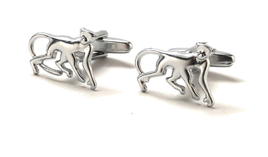 Silver monkey cufflinks on a white background