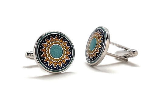 Round cufflinks with decorative design on a white background