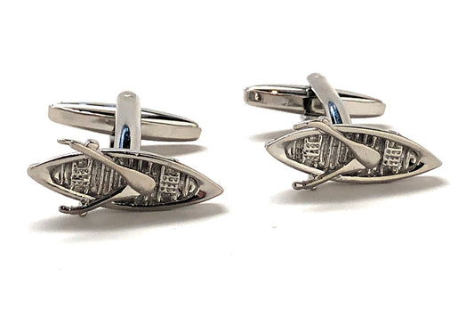 Silver fish and paddle cufflinks on a white background