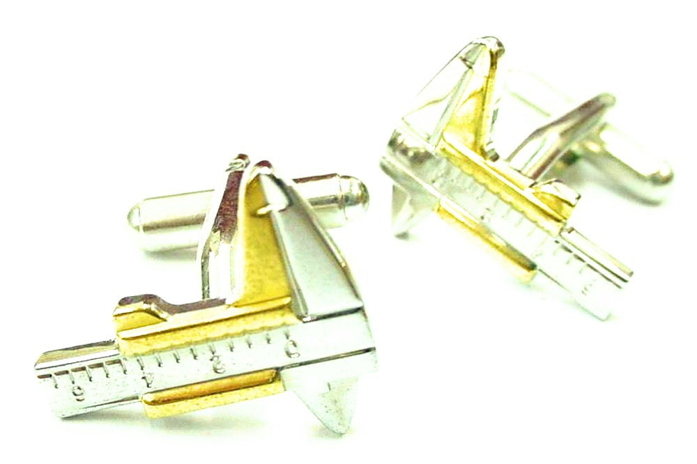 Gold and silver sailboat cufflinks on a white background