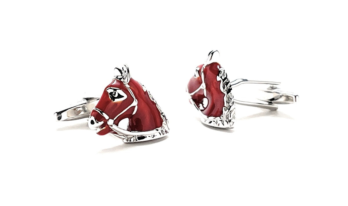 Red horse head cufflinks on a white background