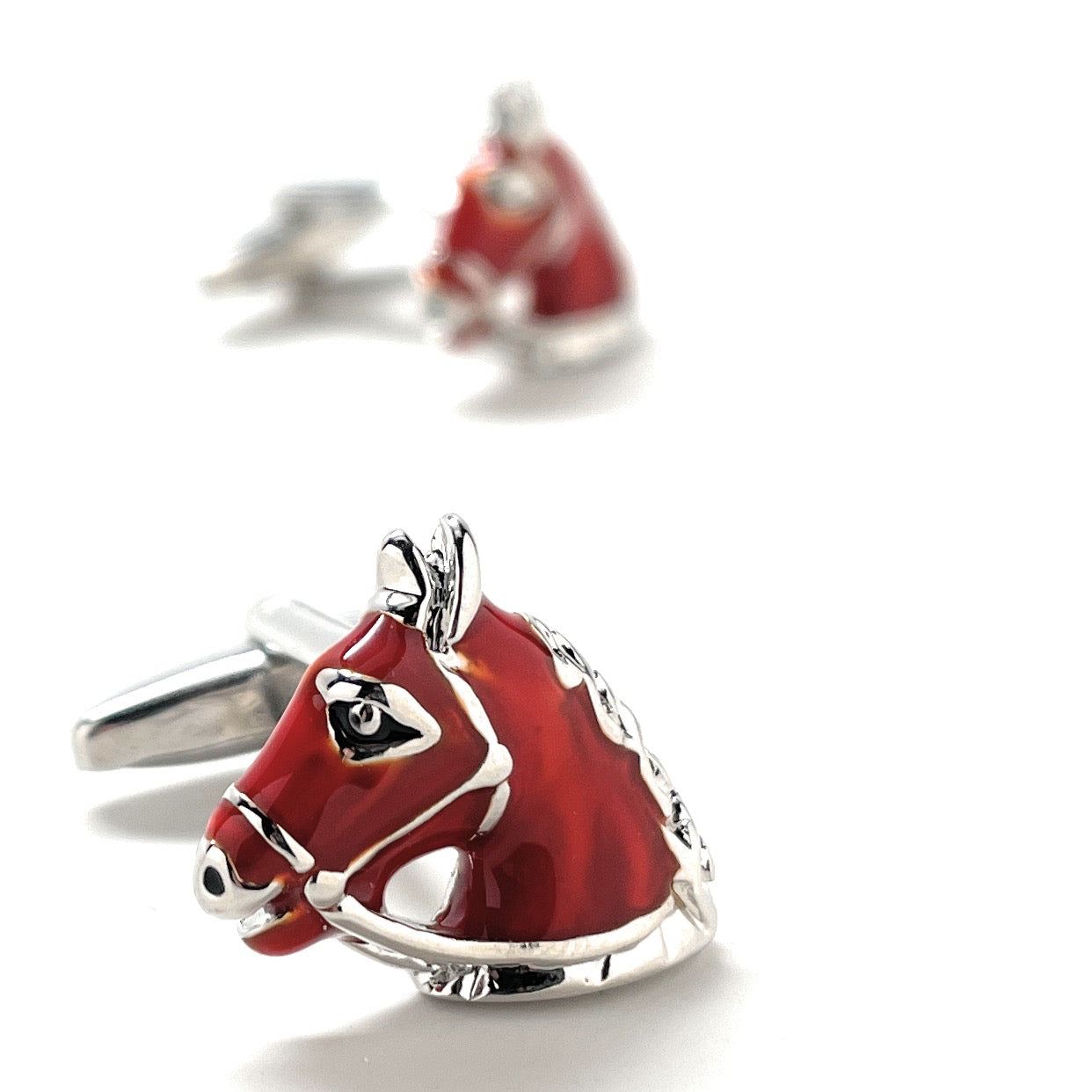 Red horse-shaped cufflinks on a white background