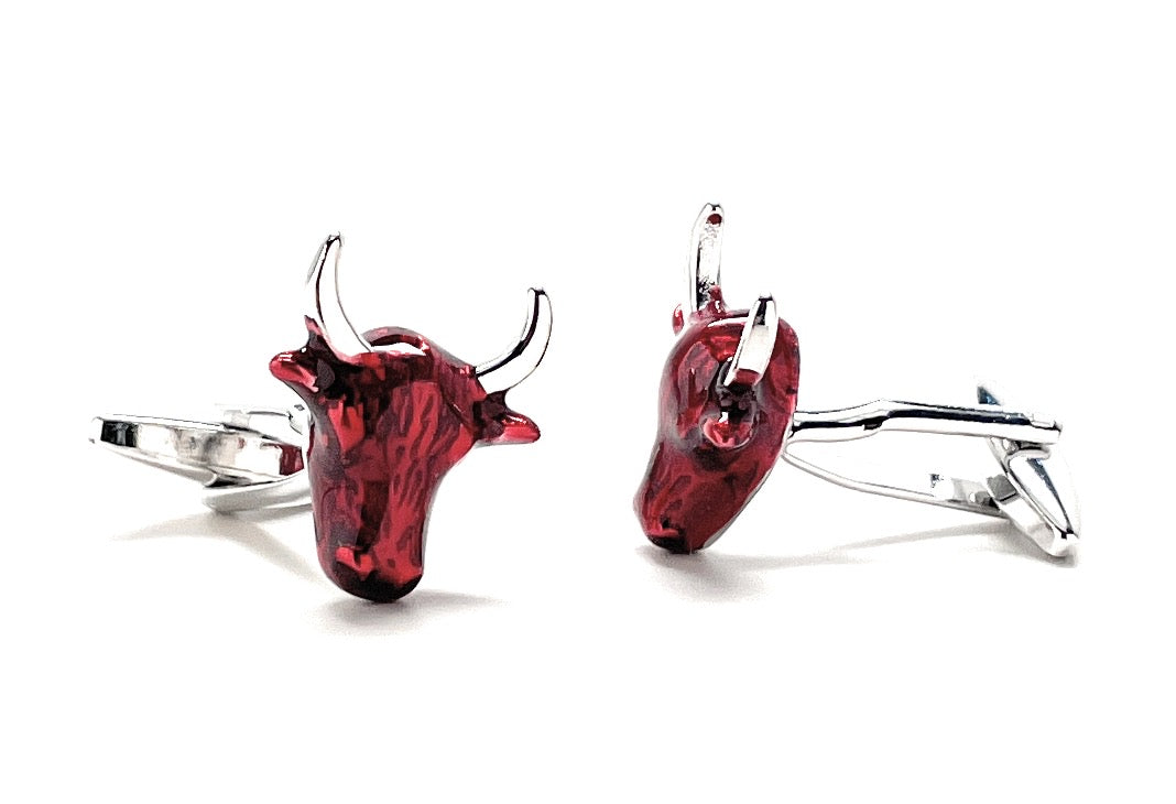 Red bull head cufflinks on a white background