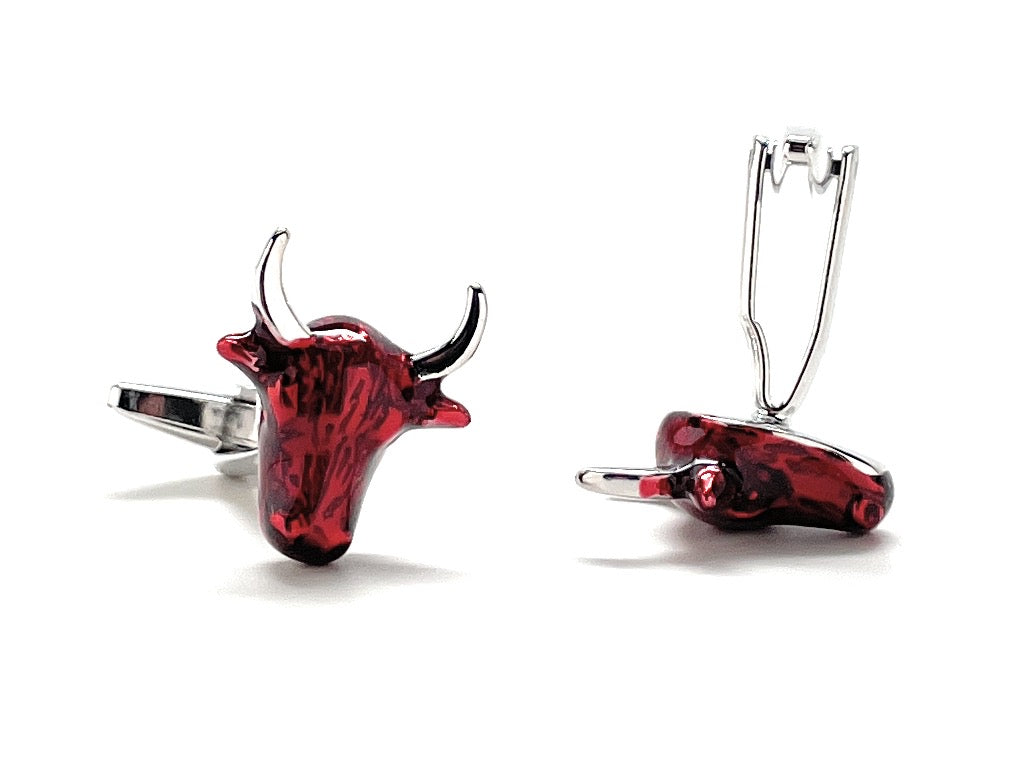 Red bull head cufflinks on a white background