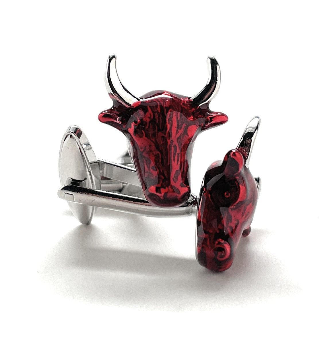 Red and silver bull-shaped cufflinks on a white background