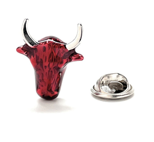 Red and silver bull head pin on a white background