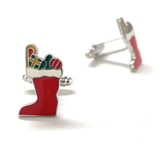 Christmas stocking cufflinks with candy cane and presents on a white background