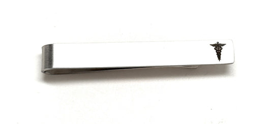 Metallic tie clip with a caduceus symbol on a white background