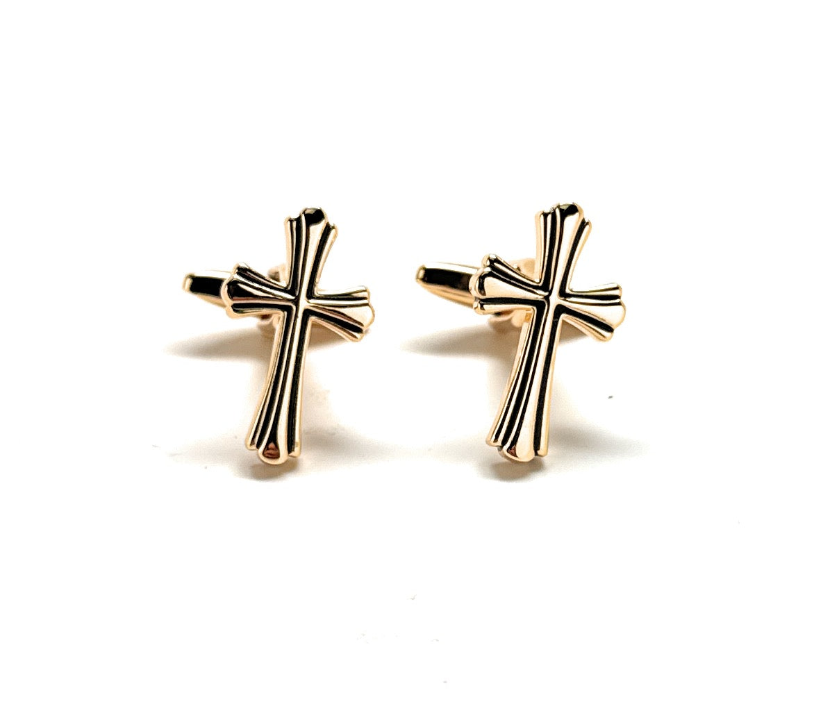 Pair of gold cross earrings on a white background