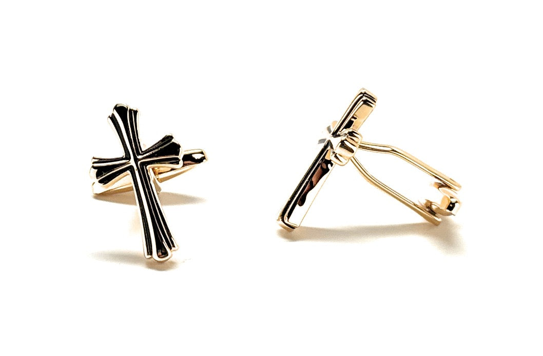 Gold and black cross-shaped earrings on a white background