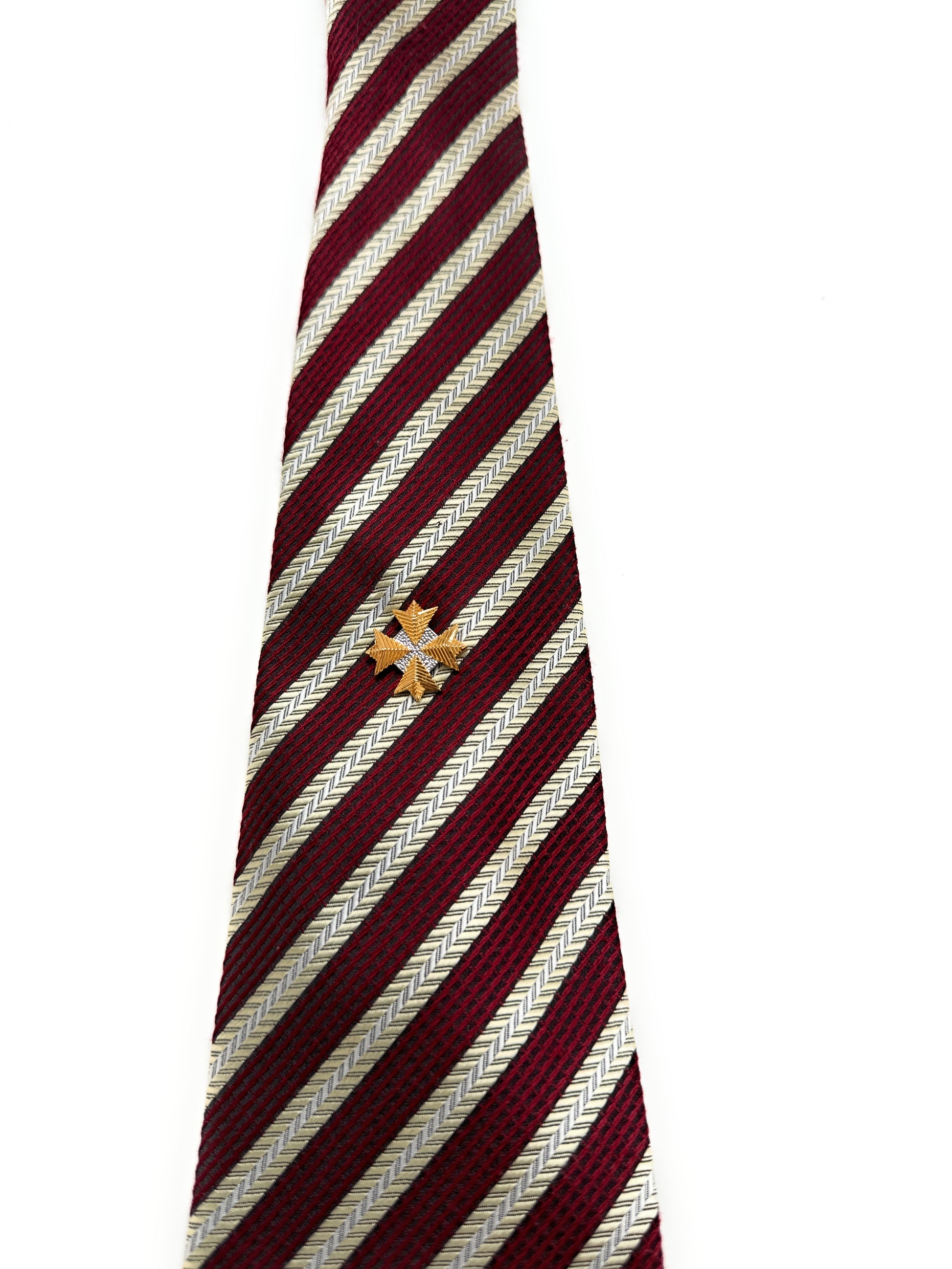 Maroon and white striped tie with a gold emblem on a white background