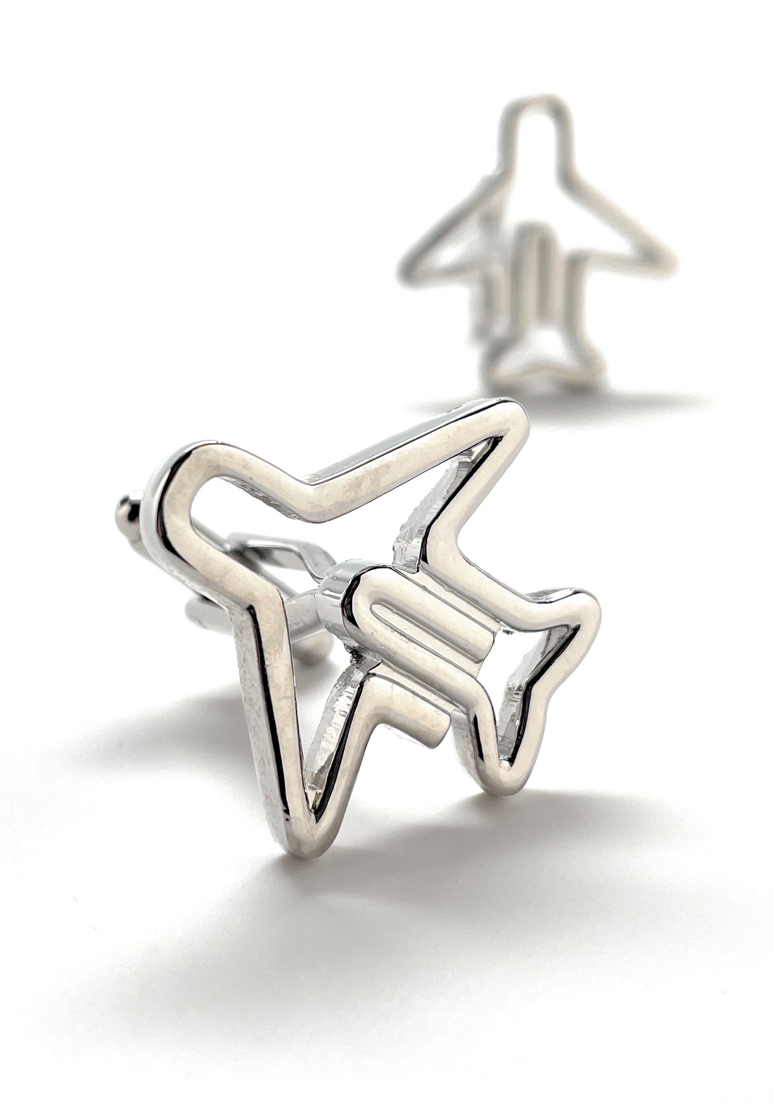 Silver airplane-shaped earrings on a white background