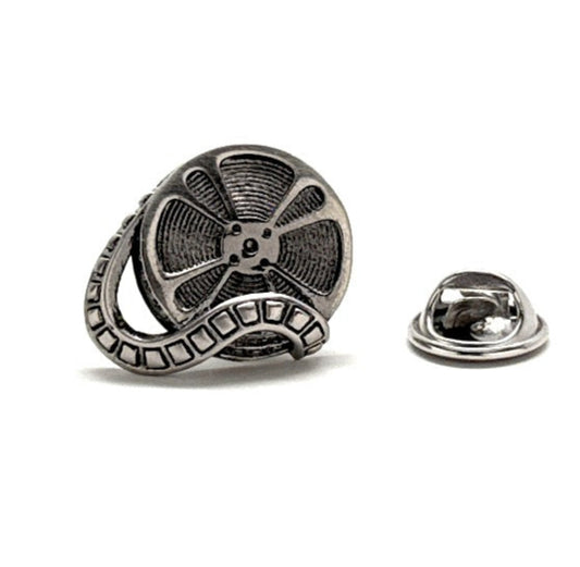 Metallic film reel lapel pin on a white background