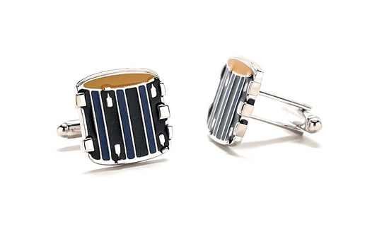 Cufflinks designed like a drum set on a white background