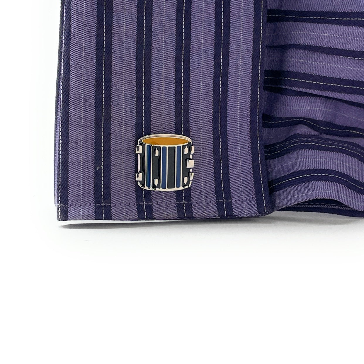 Close-up of a purple striped shirt with a decorative button on a white background