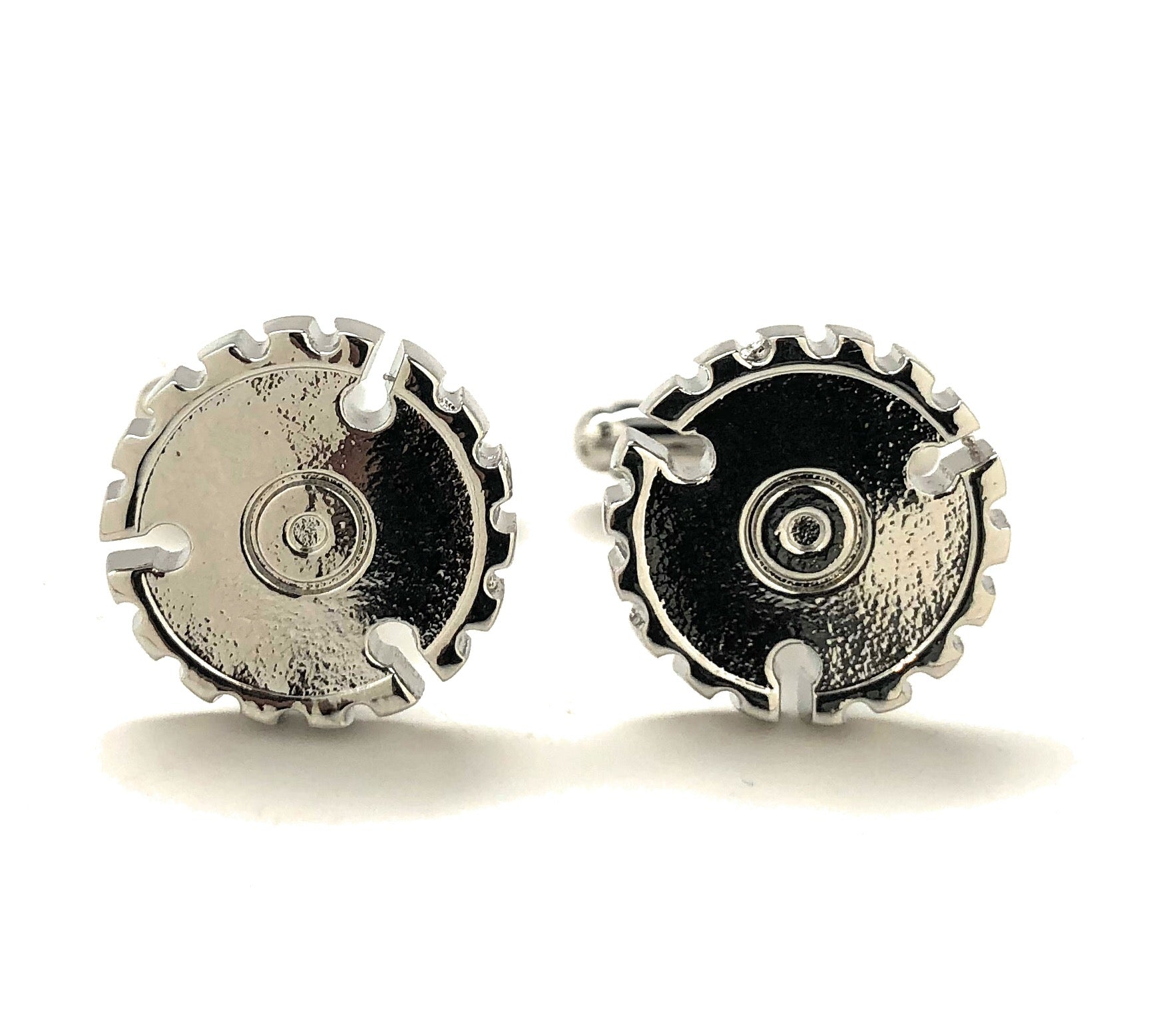 Pair of silver gear-shaped earrings on a white background