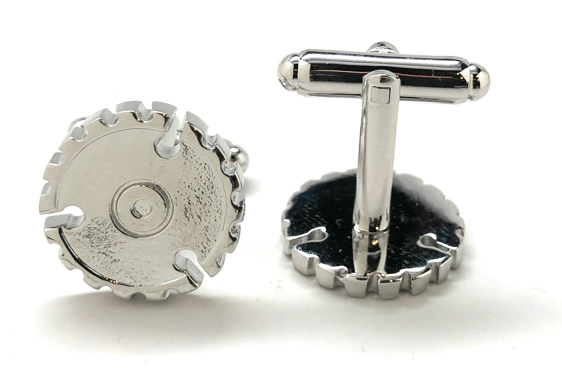 Silver gear-shaped cufflinks on a white background