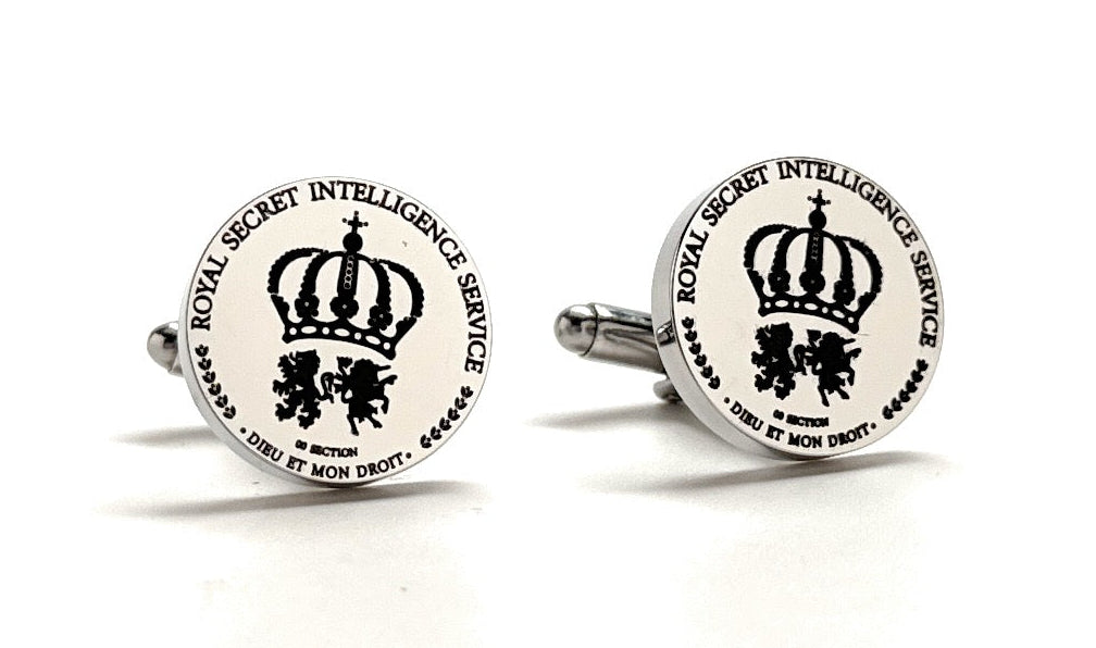 A pair of silver-toned cufflinks with a crest design, indicating a secret intelligence service theme, complete with a rhodium plated metal base.