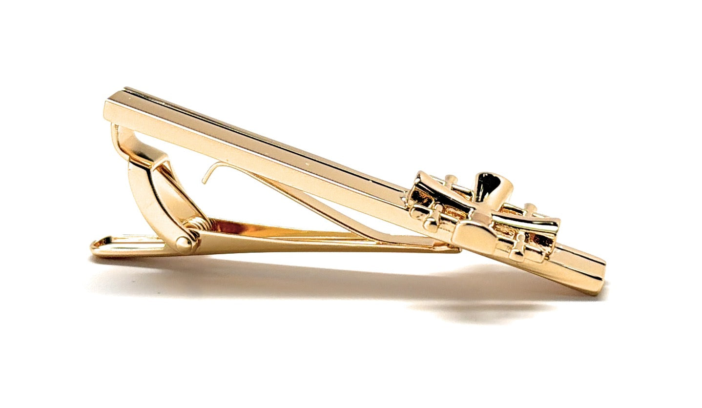 Gold tie clip on a white background