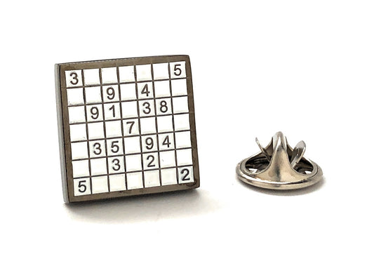 Sudoku puzzle lapel pin with black numbers on a white enamel grid and metal clutch backing