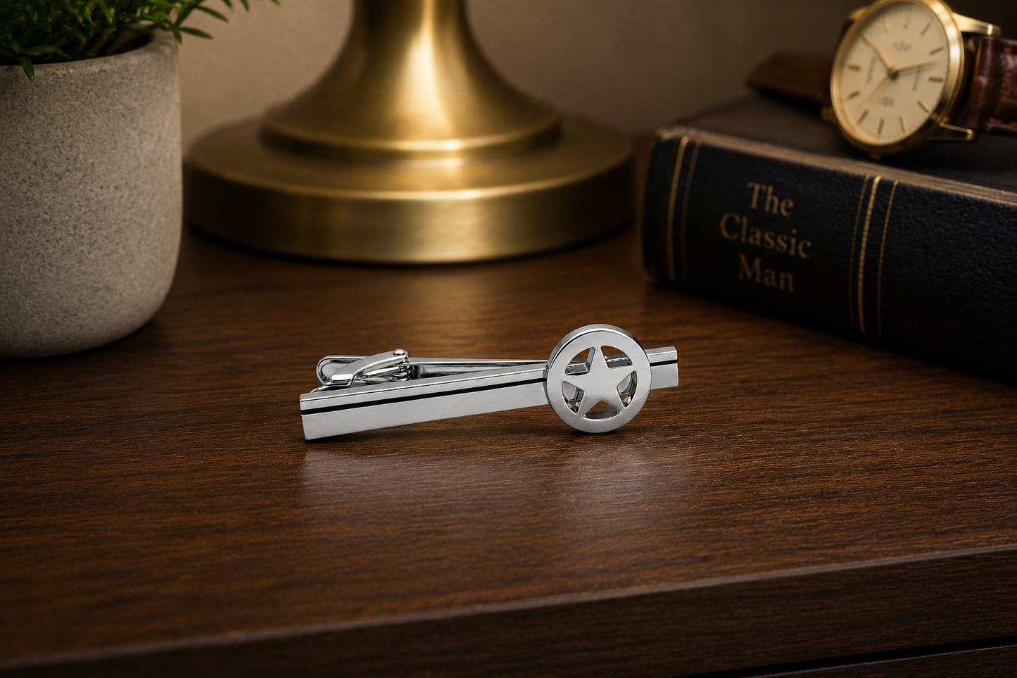 Silver Lone Star Tie Clip for Men with polished Texas star design and black accent stripe on a white background on nighttand