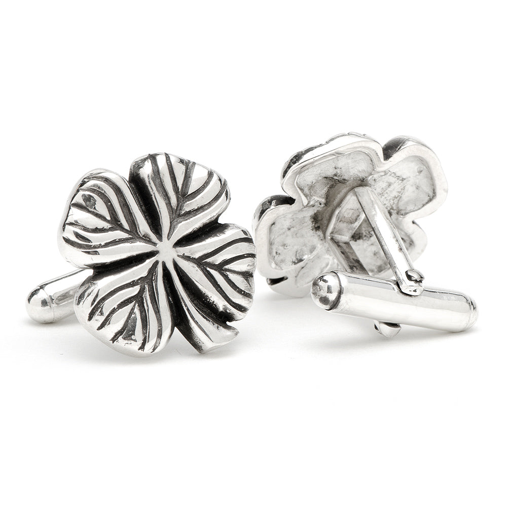 Silver four-leaf clover cufflinks on a white background