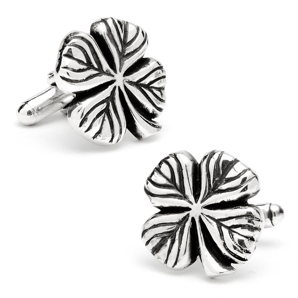 Silver four-leaf clover cufflinks on a white background