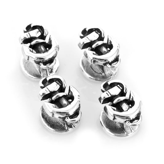 Four silver metal beads with a textured design on a white background