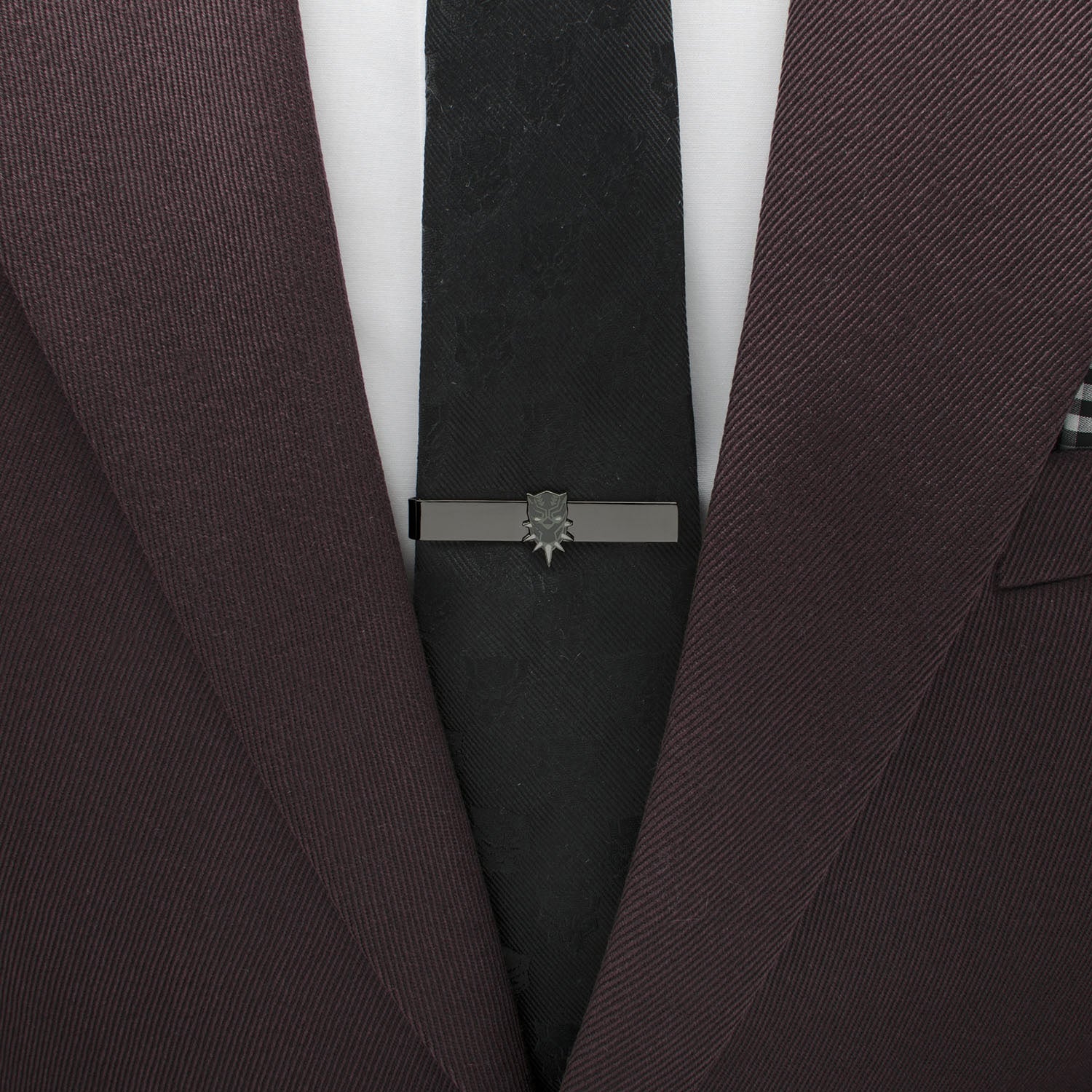 Brown suit jacket with a black tie and silver tie clip on a white background