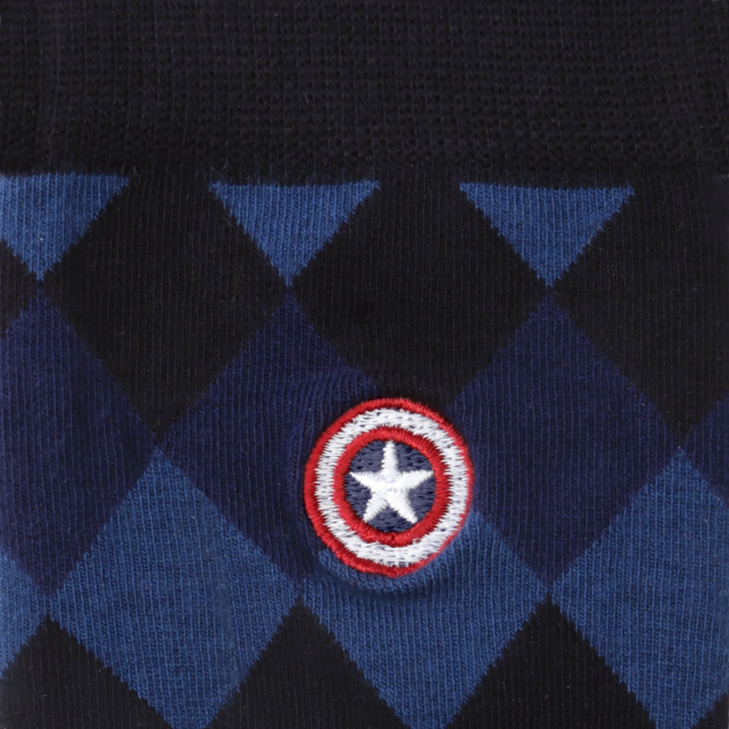 Close-up of a blue and black patterned fabric with a Captain America shield emblem.