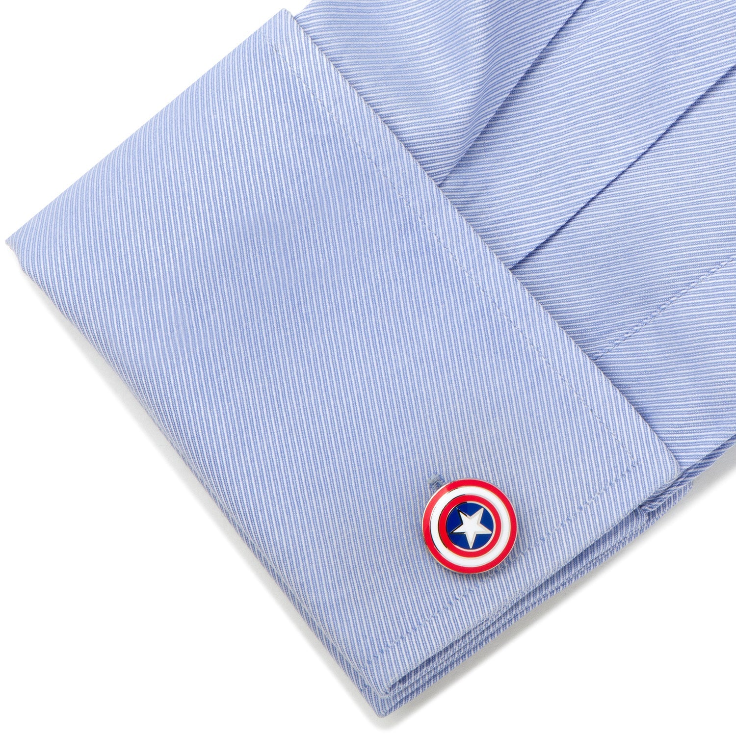 Cufflink with a superhero emblem on a light blue striped shirt