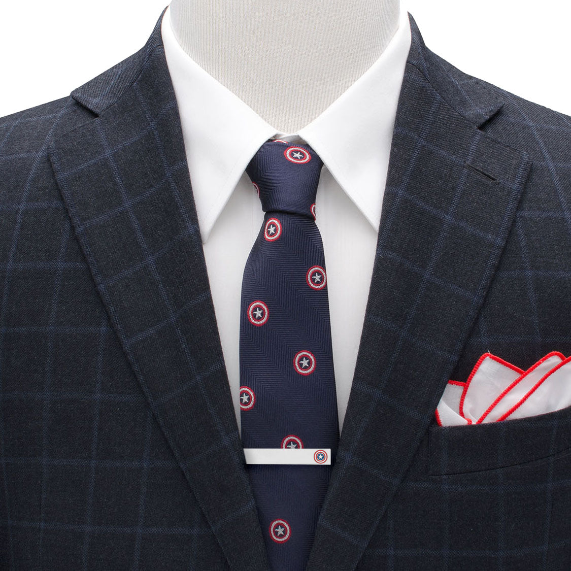 Navy suit with a patterned tie and matching pocket square on a mannequin.