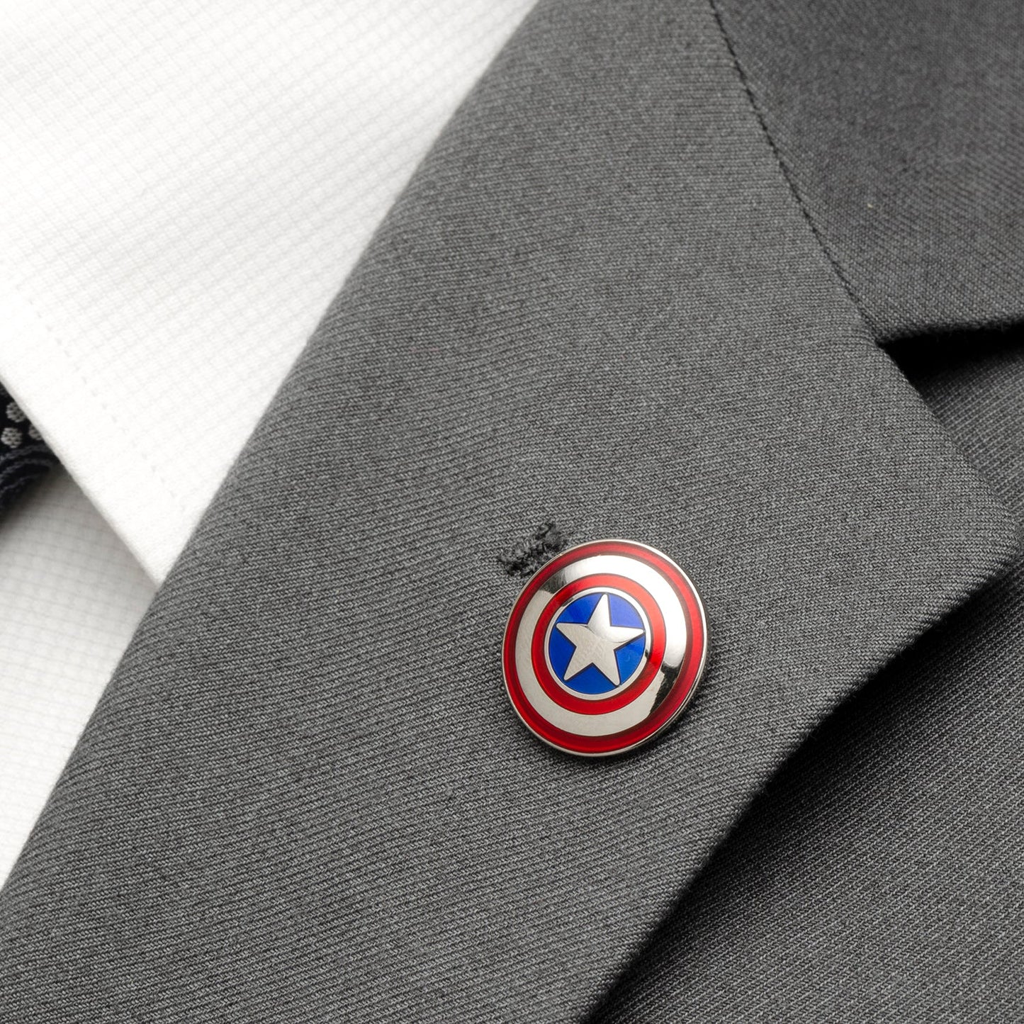 Captain America shield pin on a gray suit jacket