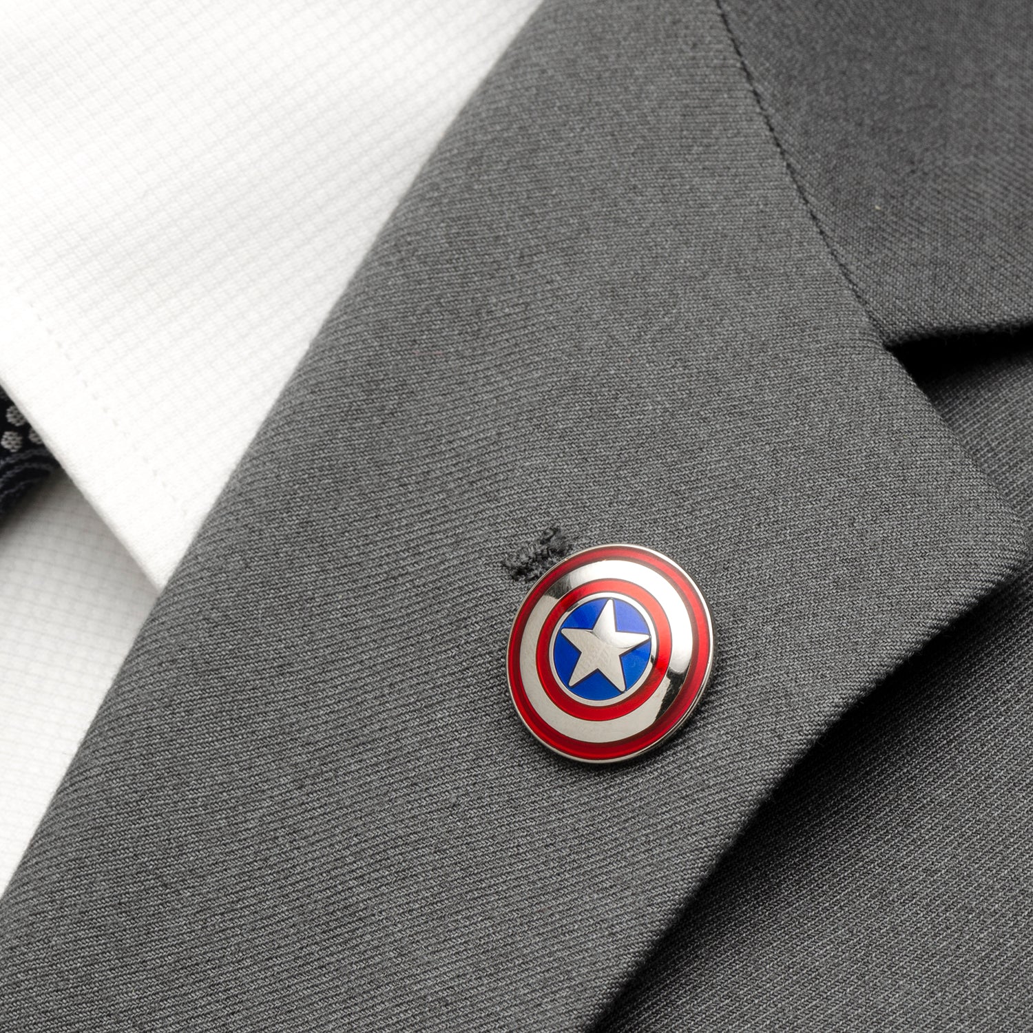 Captain America shield pin on a gray suit jacket