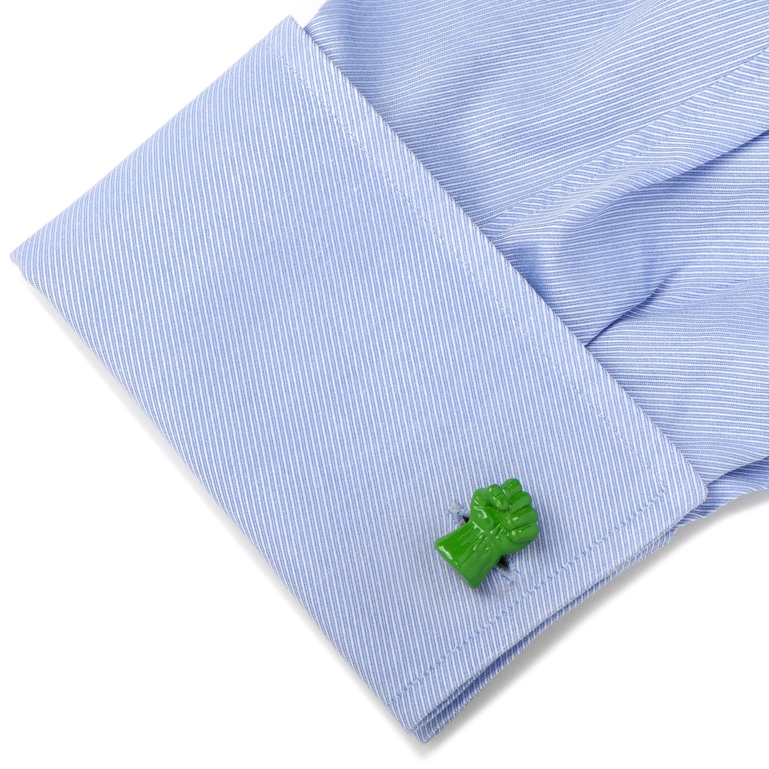 Green frog-shaped cufflink on a light blue striped shirt cuff.
