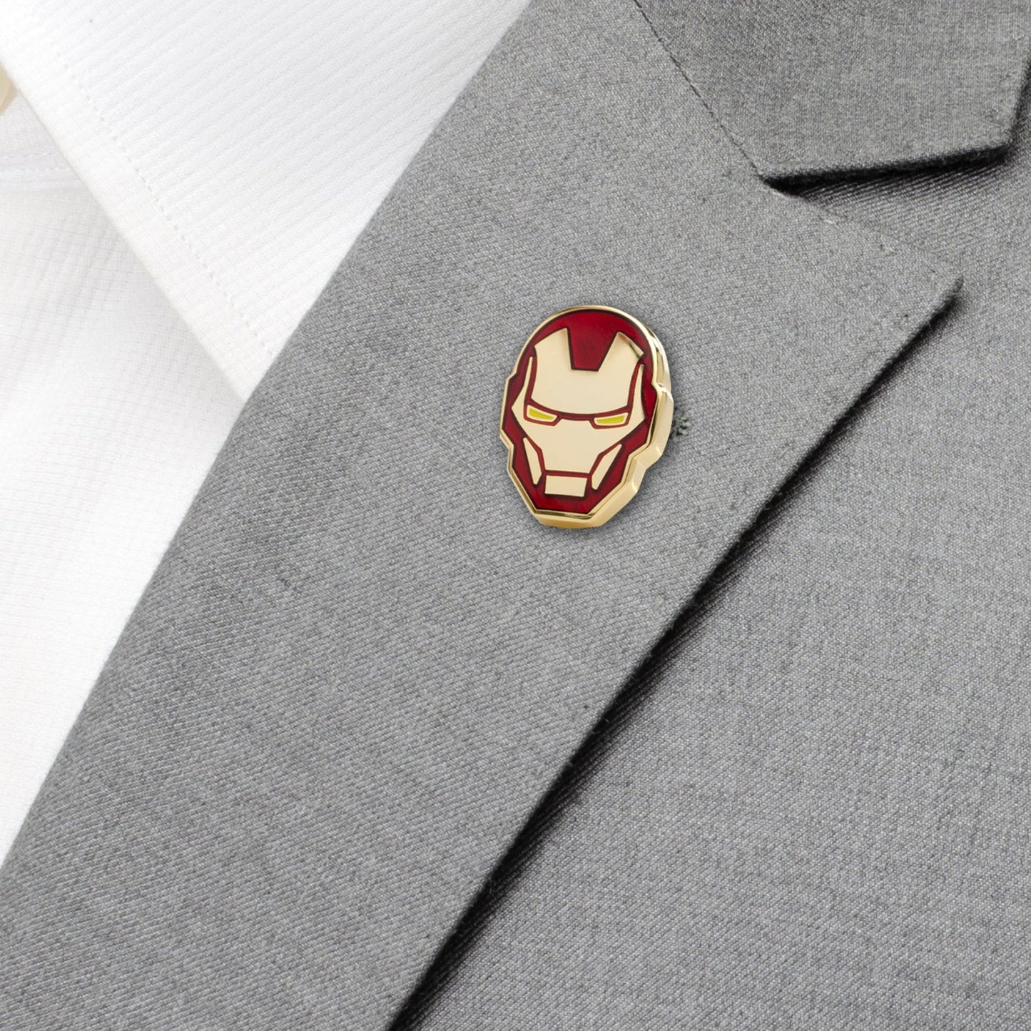 Iron Man helmet pin on a gray suit jacket