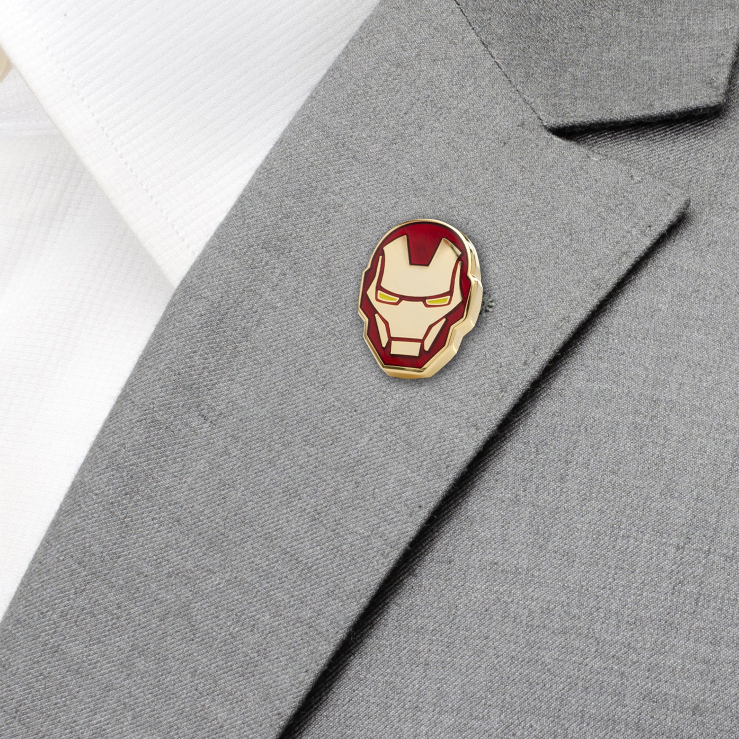 Iron Man helmet pin on a gray suit jacket