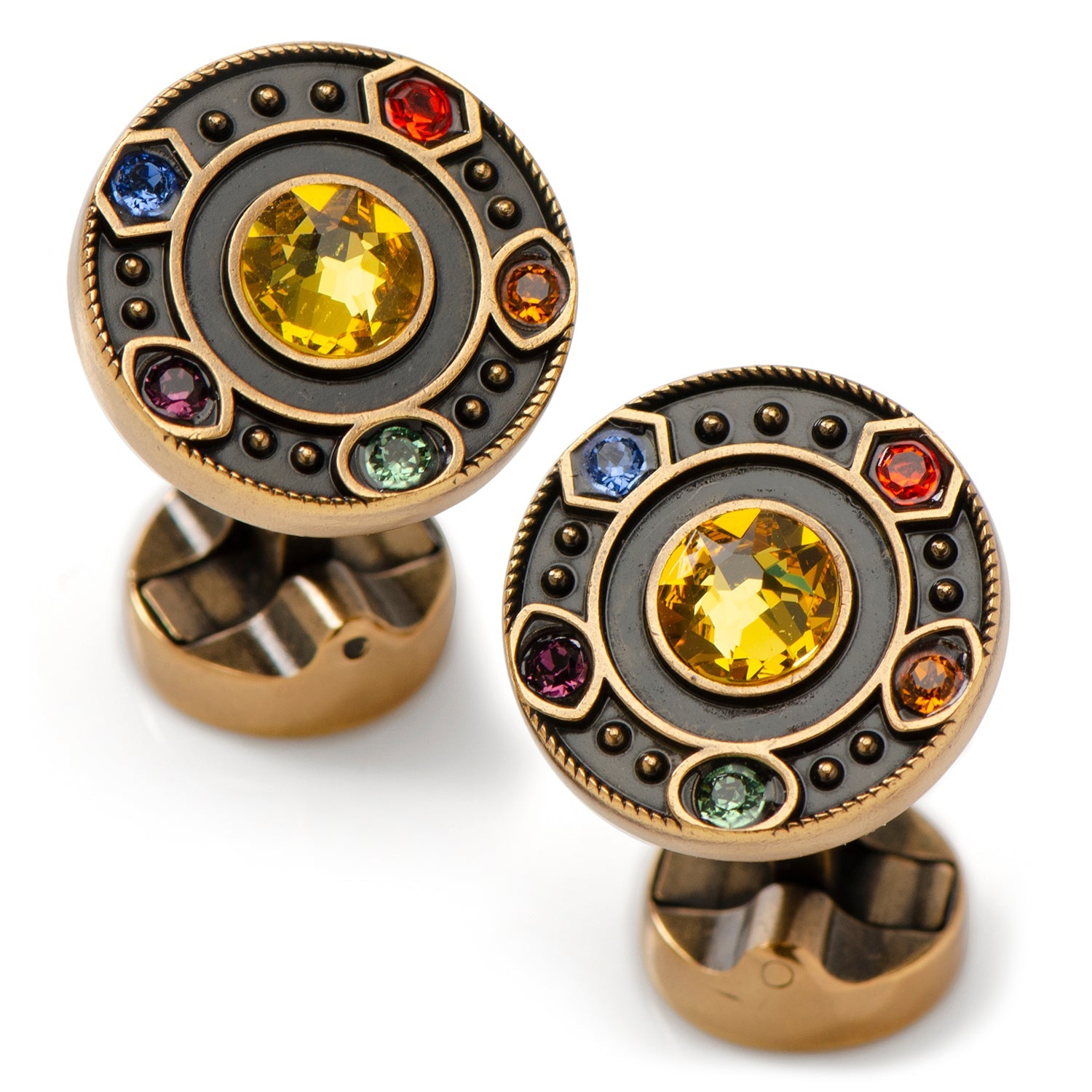 Pair of cufflinks with yellow gemstones and multicolored stones on a white background