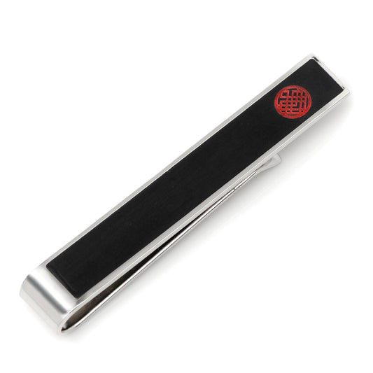 Silver tie clip with black bar and red emblem on a white background