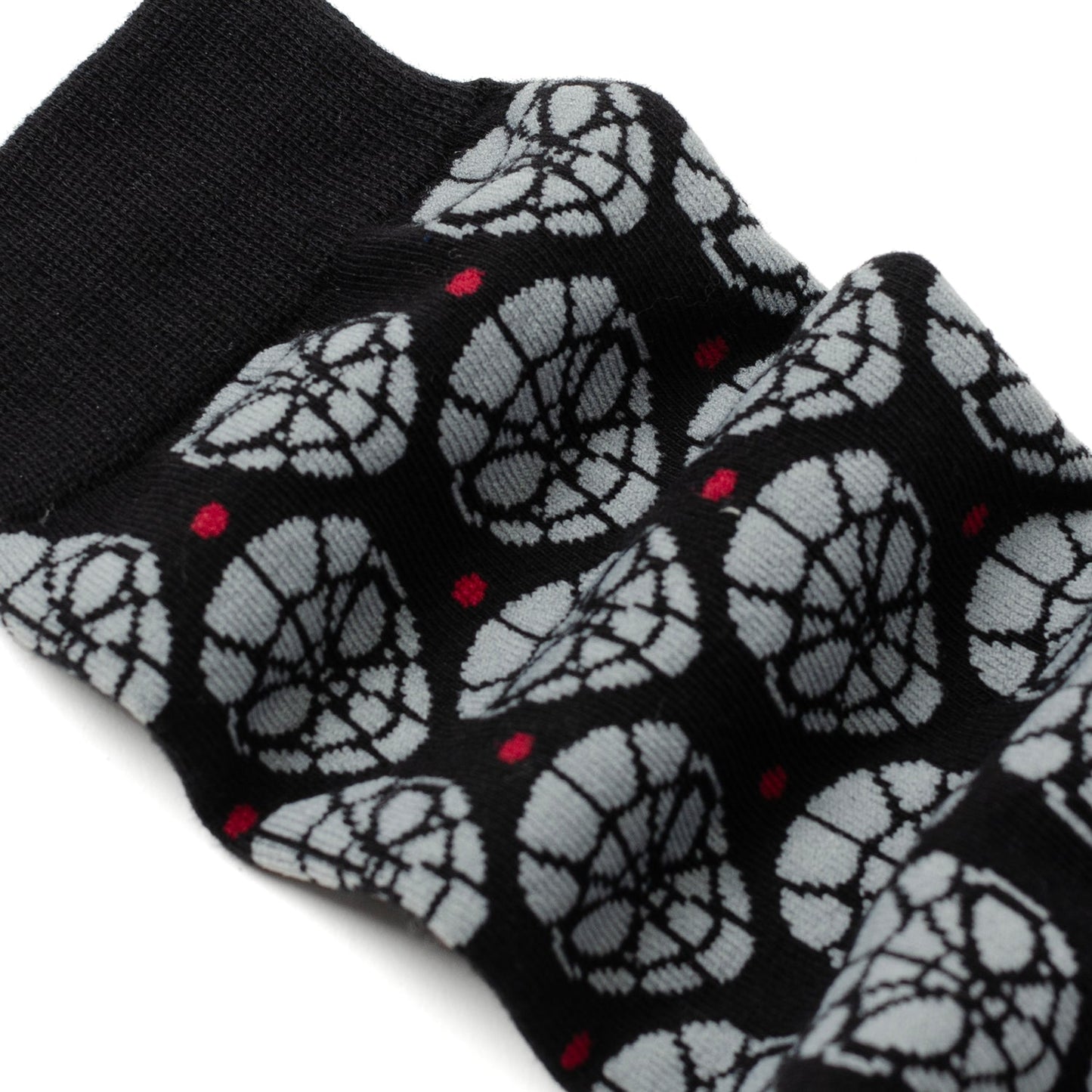 Black socks with white spider web pattern on a white background