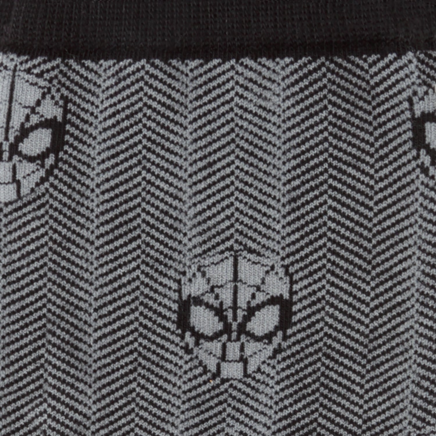Close-up of a black and gray patterned fabric with spider-like designs.