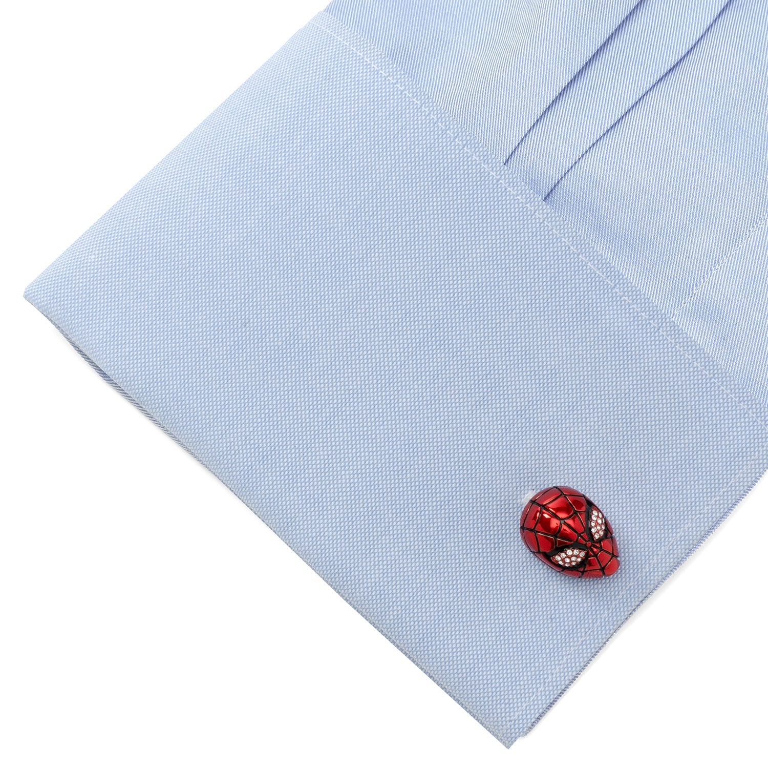 Red cufflink on a light blue shirt